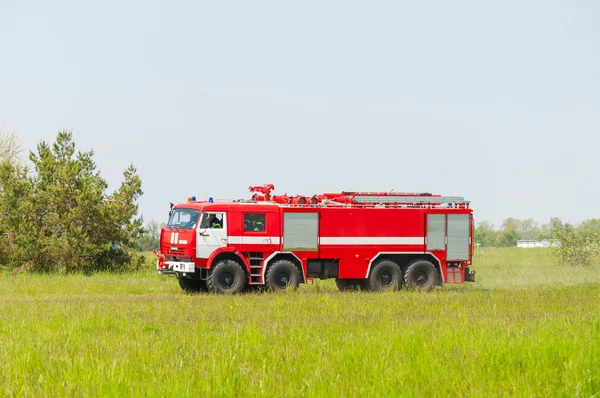 BORYSPIL, UKRAINE - MAY, 20, 2015: Red firetruck Kamaz ride on alarm for instruction for fire suppression and mine victim assistance at Boryspil International Airport, Kiev, Ukraine.