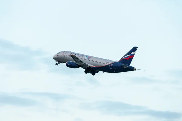 KIEV, UKRAINE - JULY 10, 2015: Aeroflots  SSJ 195-b take off at KBP Airport on January 12, 2014. Aeroflot is flag carrier and largest airline of the Russian Federation.