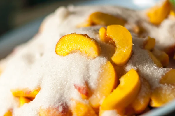 Peach slices with sugar, cooking jam. Selective focus