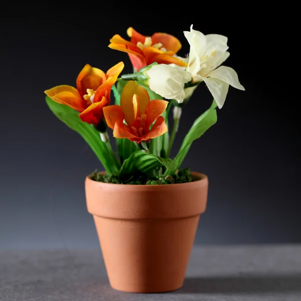 Artificial flowers in pot