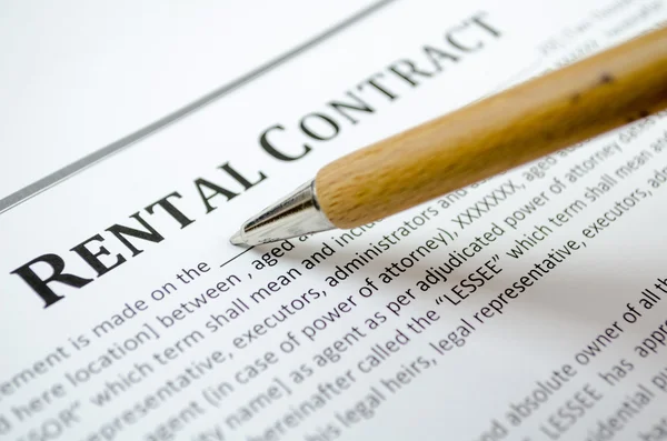 Filling a rental contract with wooden pen