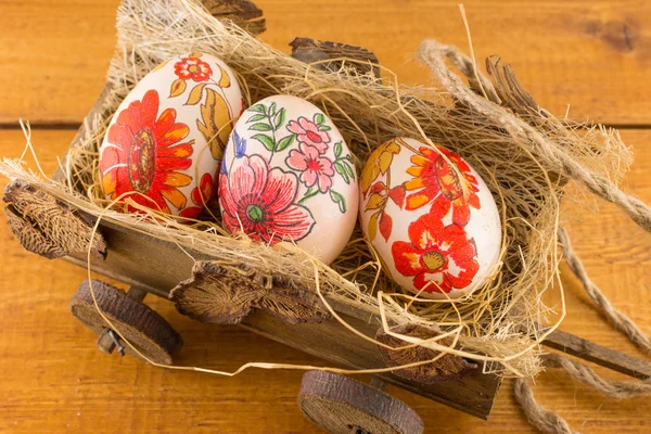 Decoupage decorated Easter eggs in old wagon