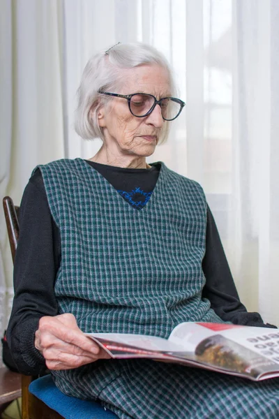 Ninety years old lady reading newspapers