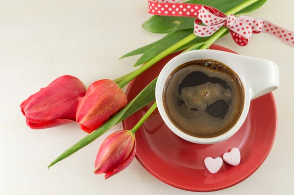 Red tulips with a cup of coffee