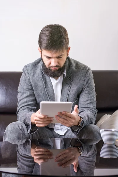 Businessman reading from tablet