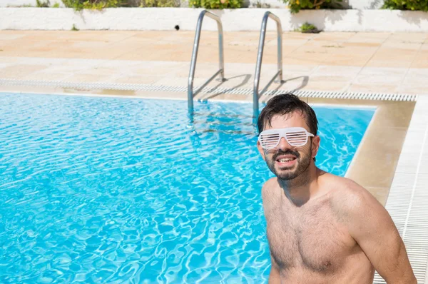 Young men in the swimming pool ready for party