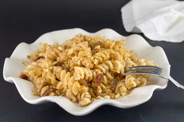 Sweet pasta with honey, nuts and raisins