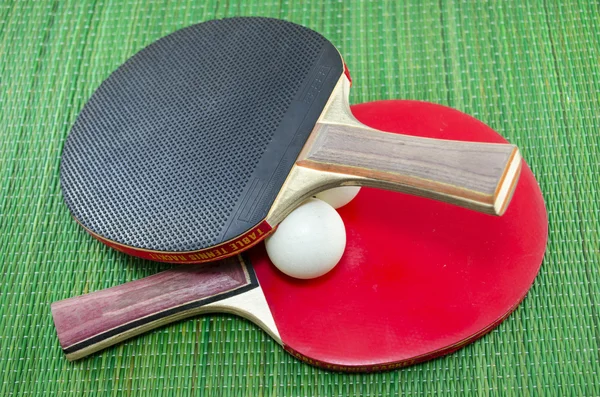 Two vintage table tennis rackets and ping pong balls