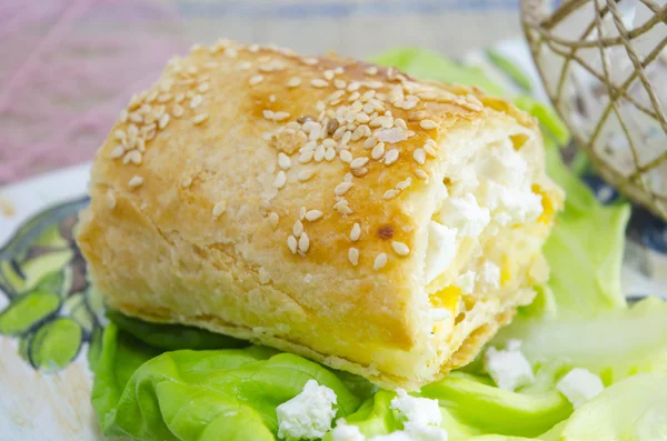 Homemade cheese pie with green salad on a tray