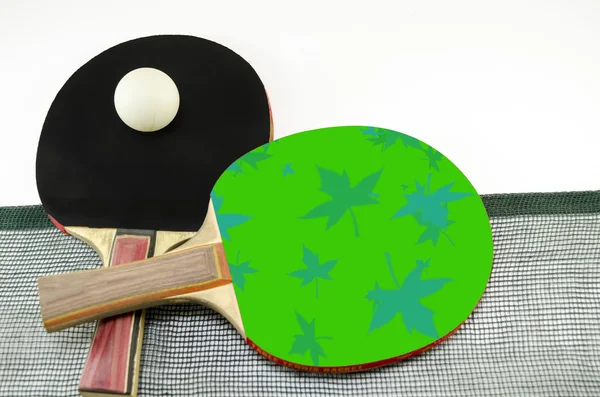Two table tennis rackets and a net isolated