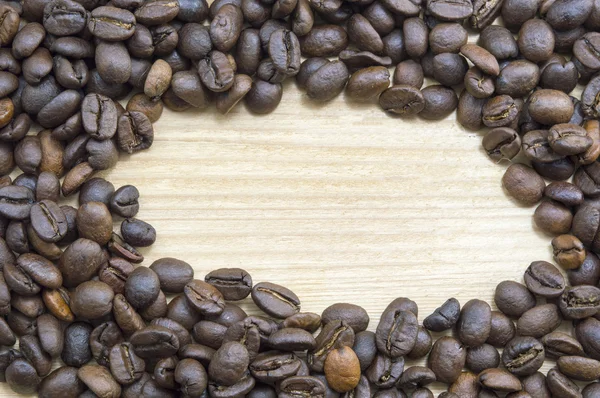 Coffee beans on a wooden table with round copyspace