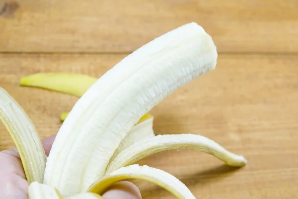 Peeled banana and banana skin