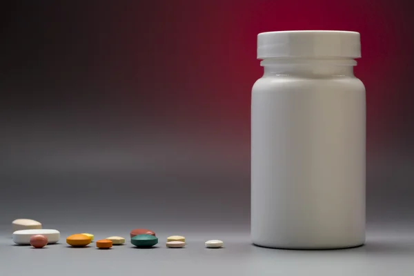 Plastic white medicine pill bottle on a colorful background