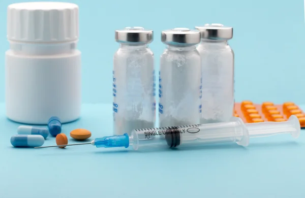 Colorful pills, medical bottle and injection syringe