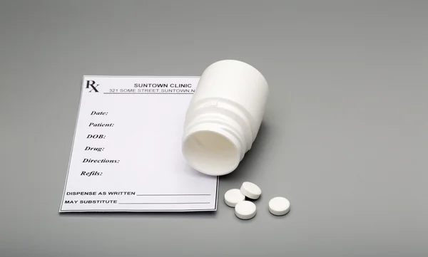 Prescription blank and open pill bottle