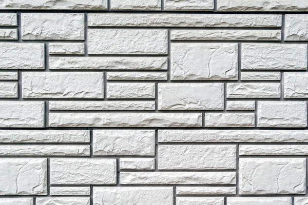 Surface of wall, decorated with rectangular panels with horizontal artificial stone texture