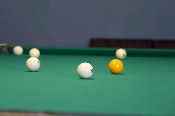 Large pool table for Russian billiards with balls on the table.