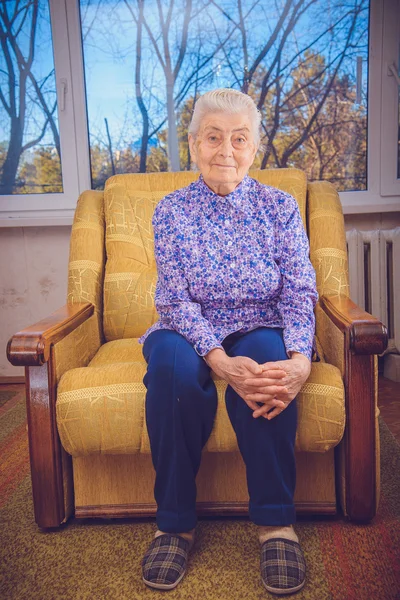 Grandma sitting in a yellow chair