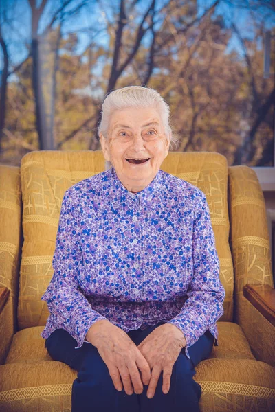 An elderly grandmother laughs