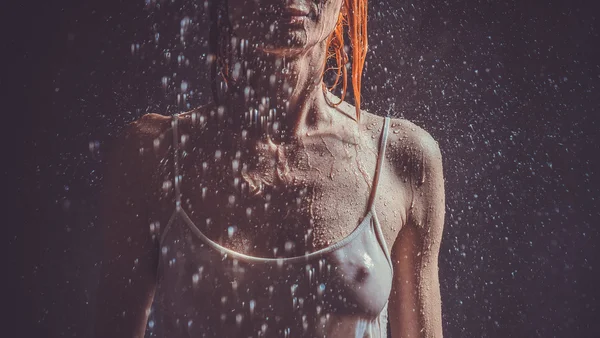 Shower. Girl in a white T-shirt standing under a shower.