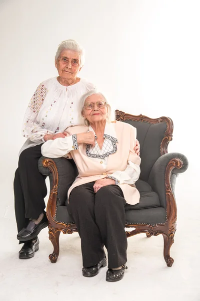 Grandmothers. Two grandmothers sitting in the chair. Two sisters