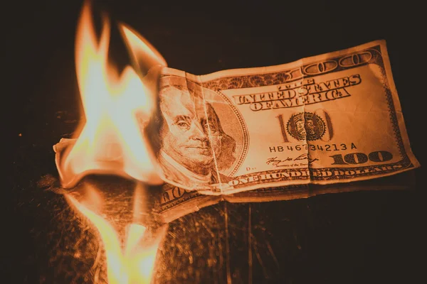 One hundred dollar bill on fire. Treatment with toning effect