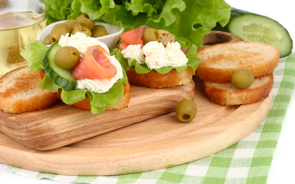 Salmon, lettuce and fresh cucumber sandwiches on a white background.