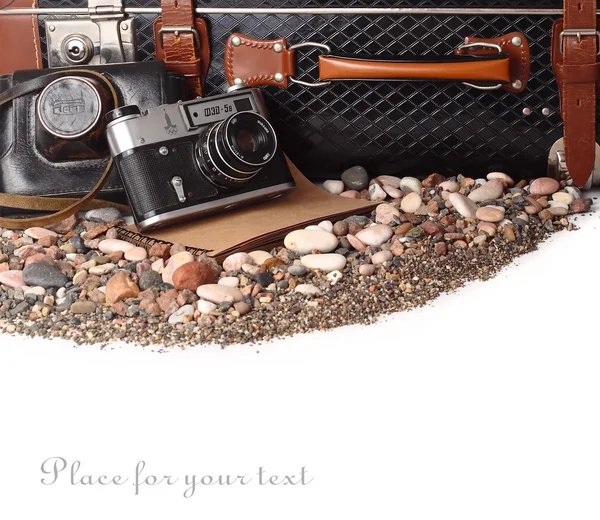 Old suitcase, the camera and hat on a white background. Retro travel.