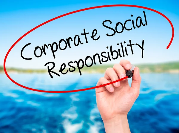 Man Hand writing Corporate Social Responsibility with black mark