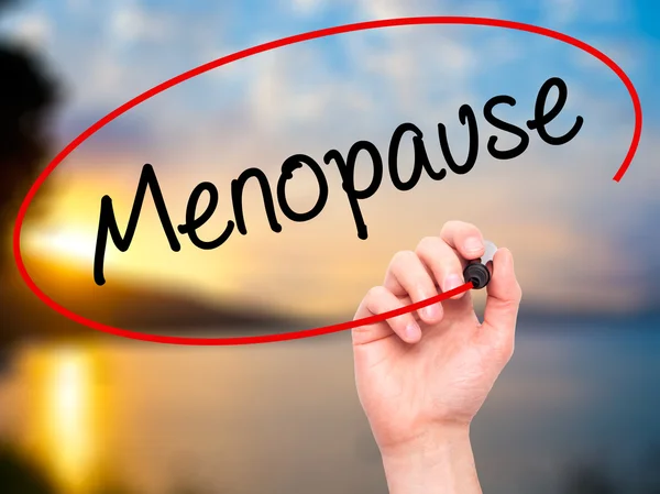 Man Hand writing Menopause with black marker on visual screen.