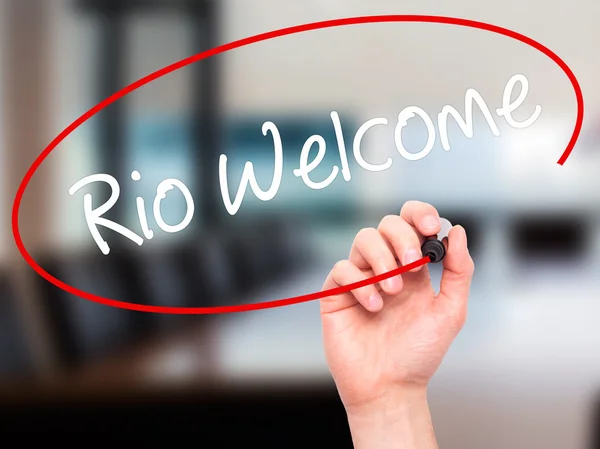 Man Hand writing Rio Welcome with black marker on visual screen.