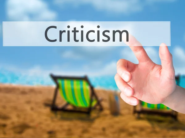 Criticism - Hand pressing a button on blurred background concept