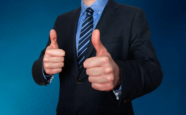 Businessman Giving a Thumbs Up. Blue background - Stock Image