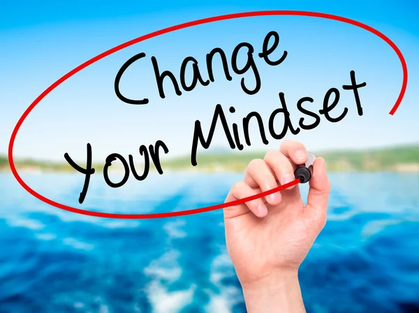 Man Hand writing Change Your Mindset with black marker on visual