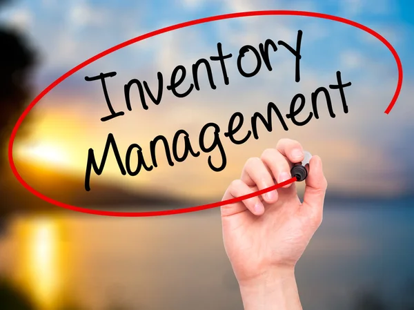 Man Hand writing Inventory Management with black marker on visua