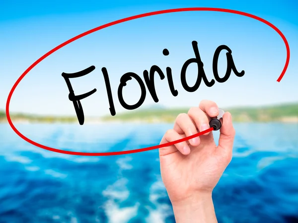 Man Hand writing Florida  with black marker on visual screen
