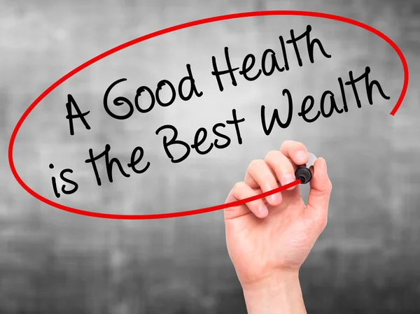 Man Hand writing A Good Health is the Best Wealth with black mar