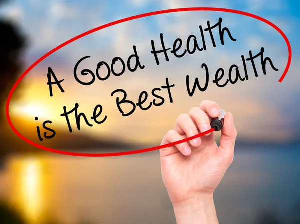 Man Hand writing A Good Health is the Best Wealth with black mar