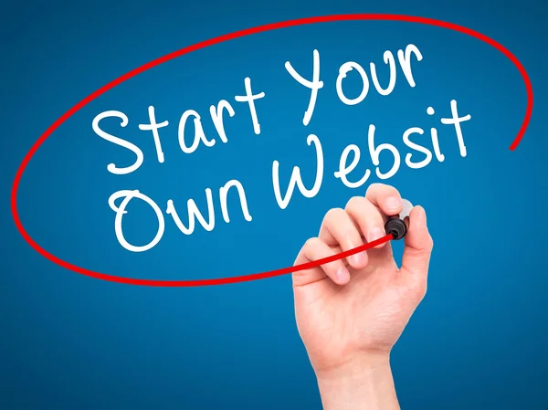 Man Hand writing Start Your Own Website with black marker on vis