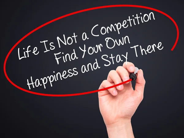 Man Hand writing Life Is Not a Competition Find Your Own Happine