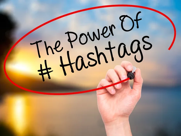 Man Hand writing The Power of Hashtags with black marker on visu