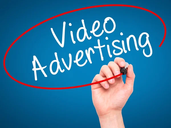 Man Hand writing Video Advertising with black marker on visual s