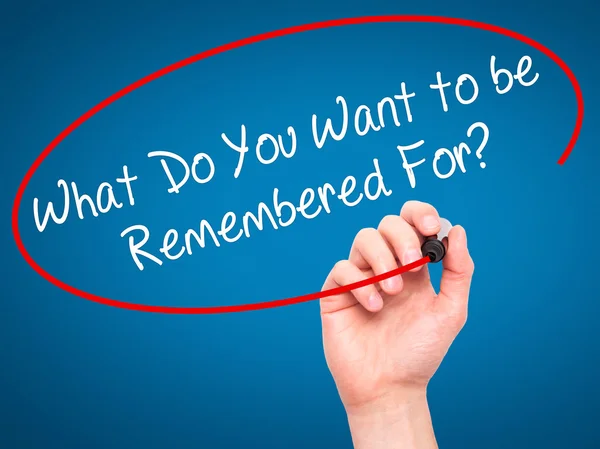 Man Hand writing What Do You Want to be Remembered For? with bla