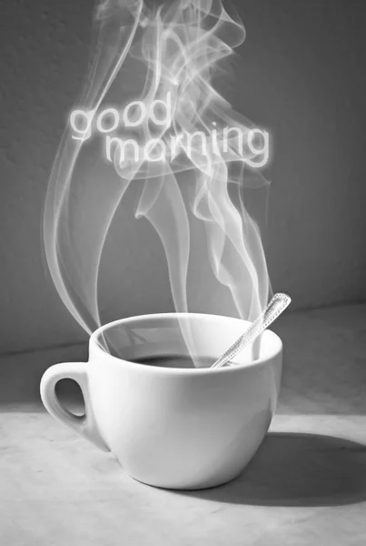 Cup of coffee with steam and good morning text