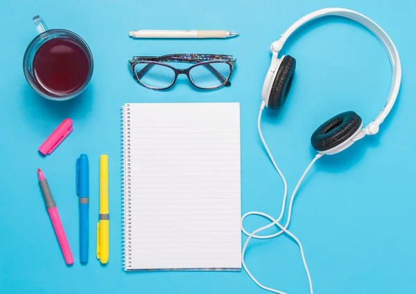 Writing tools on blue background top view