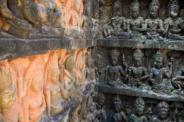 Gods figures engraved on stone wall