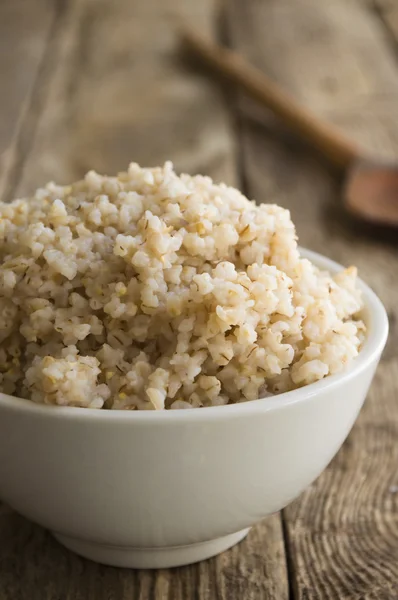 Porridge crushed wheat on a wooden background