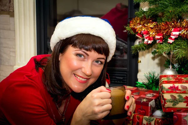 Young beautiful woman drinking cocoa.