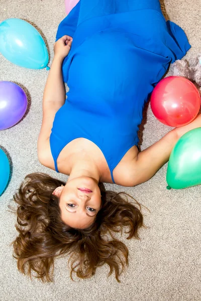 Pregnant woman lying on the floor.