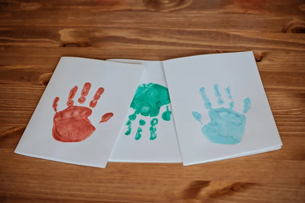 Christmas handprints post cards templates on wooden table